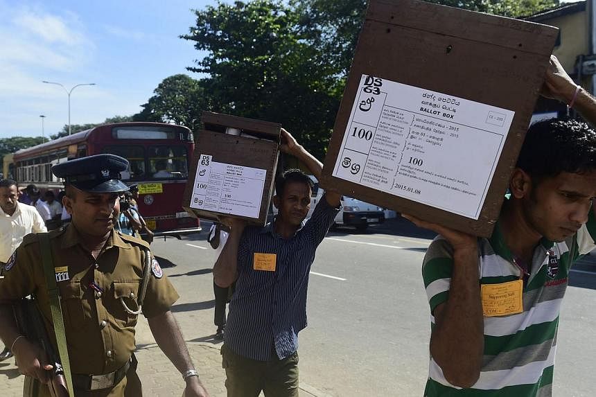 Sri Lankan election commission workers carrying ballot boxes on the eve of presidential elections in Colombo on Jan 7, 2015. -- PHOTO: AFP