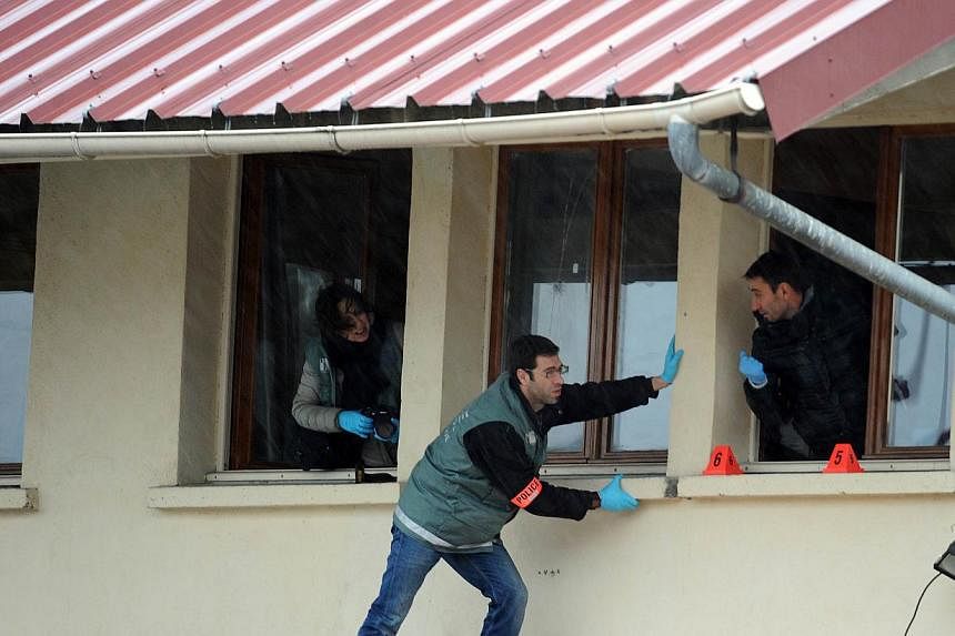 Members of the French technical and scientific police work at a mosque in the Sablons neighborhood of Le Mans, western France, on Jan 8, 2015, after shots were fired and three blank grenades were thrown at the mosque shortly after midnight, leaving n