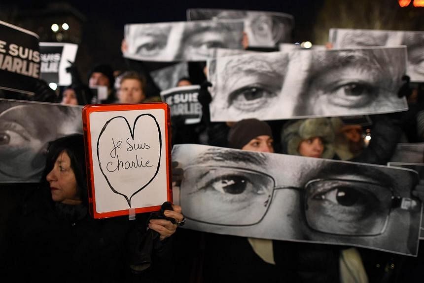 People gather on Union Square on Jan 7, 2015 in New York in memory of the victims of the attack on the offices of the satirical weekly Charlie Hebdo in Paris. -- PHOTO: AFP
