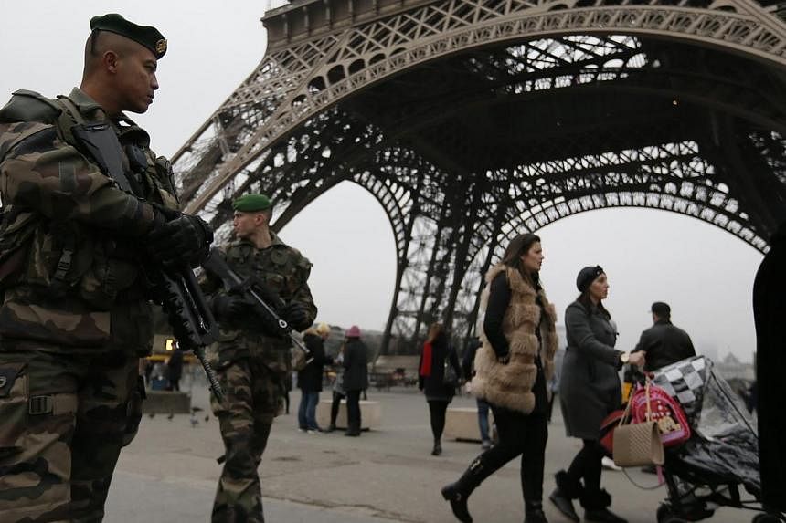 French soldiers on patrol near the Eiffel Tower in Paris, after a shooting at the Paris offices of Charlie Hebdo Jan 7, 2015.&nbsp;Troops in railway stations, armed police outside media buildings, ultra-tight security at department stores: Paris beca
