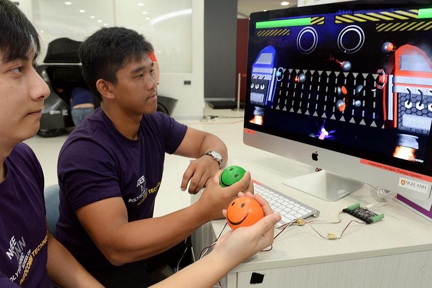 (From left) Lliow Teck Meng, 26, and Raynard Hadiwidjaja, 20, are among a team of students from Ngee Ann Polytechnic Information Technology and Multimedia Animation courses who have developed a stress ball physiotherapy system that integrates convent