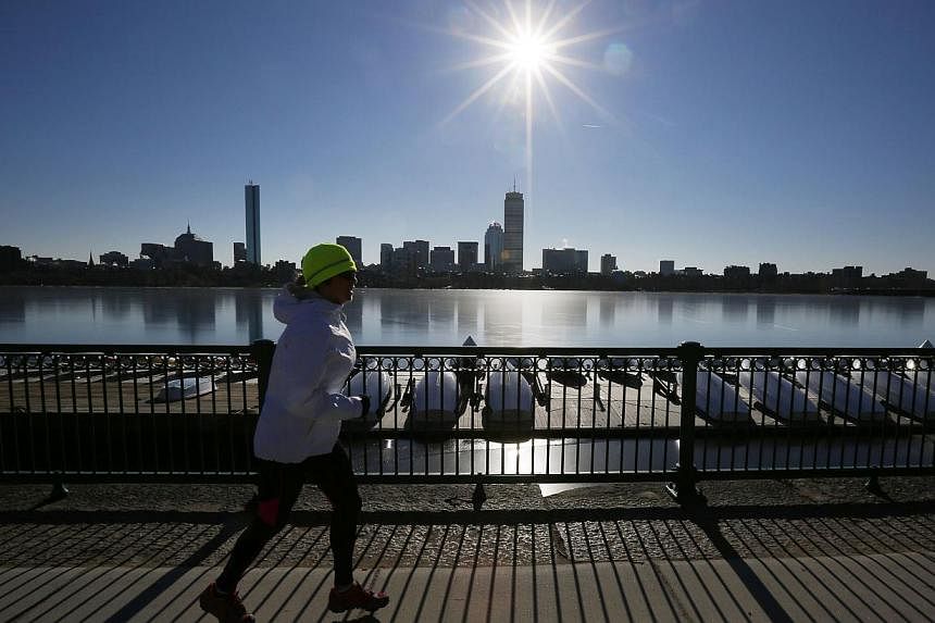 A jogger runs along the Charles River past the Boston skyline in Cambridge, Massachusetts on Jan 8, 2015. Boston has been selected as the American candidate city that will bid for the opportunity to host the 2024 Summer Olympic Games. -- PHOTO: REUTE