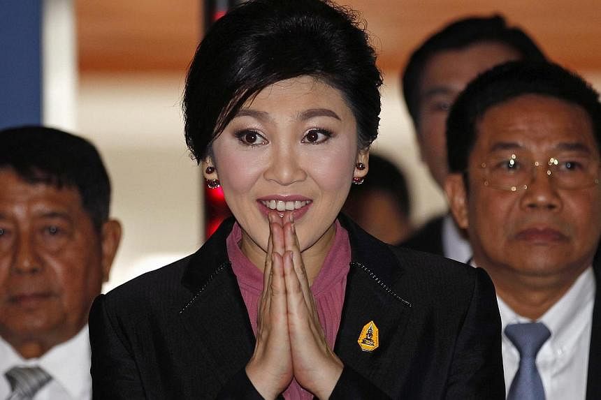 Ousted former Prime Minister Yingluck Shinawatra gesturing as she arrives at Parliament before the National Legislative Assembly meeting in Bangkok Jan 9, 2015. -- PHOTO: REUTERS