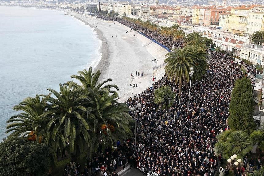 Hundreds of thousands of people march during a rally along the sea front in Nice on Jan 10, 2015, in remembrance for the victims of an attack by armed gunmen on the offices of French satirical newspaper Charlie Hebdo in Paris on Jan 7 which left at l