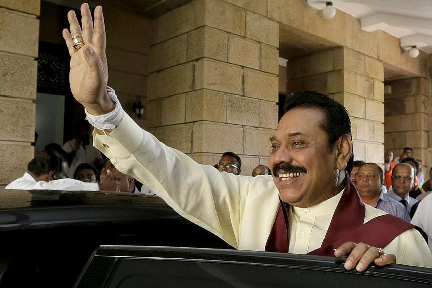 Outgoing Sri Lankan president Mahinda Rajapakse waves as he leaves his office in the capital Colombo on Jan 9, 2015. -- PHOTO: AFP