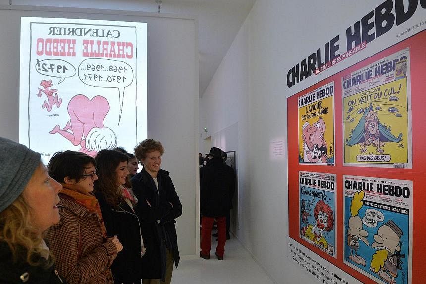 People visit an exhibition in tribute to French satirical weekly Charlie Hebdo at the museum of French illustrator and artist Jean-Thomas "Tomi" Tomi Ungerer in Strasbourg, eastern France, on Jan 9, 2015, after the deadly attack on the offices of the