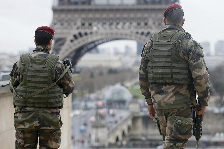 French soldier patrols near the Eiffel Tower in Paris as part of the highest level of "Vigipirate" security plan after a shooting at the Paris offices of Charlie Hebdo Jan 9, 2015. -- PHOTO: REUTERS