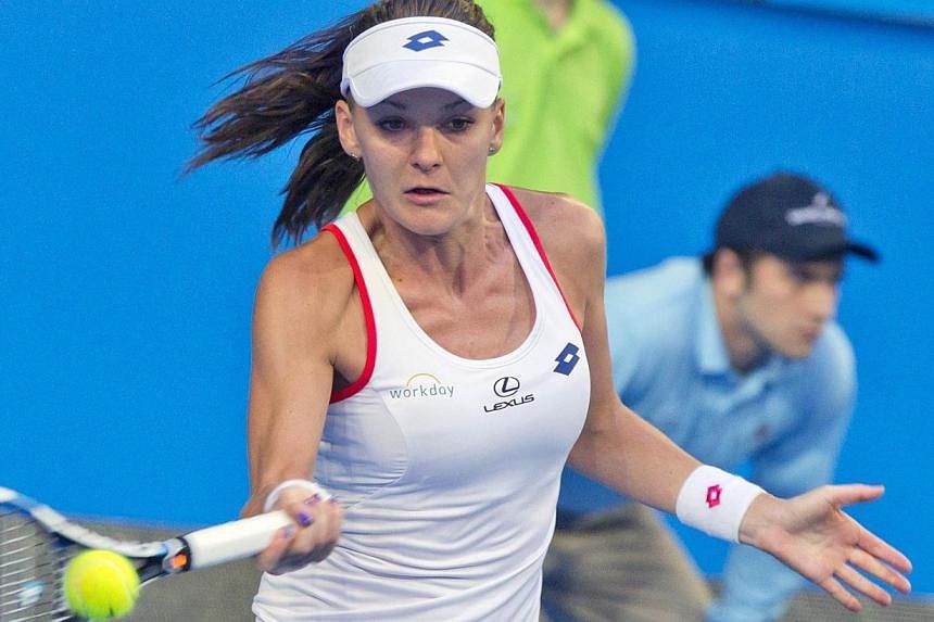 Agnieszka Radwanska of Poland hits a return against Serena Williams of the US during the final match on day seven of the Hopman Cup tennis tournament in Perth on Jan 10, 2015. -- PHOTO: AFP
