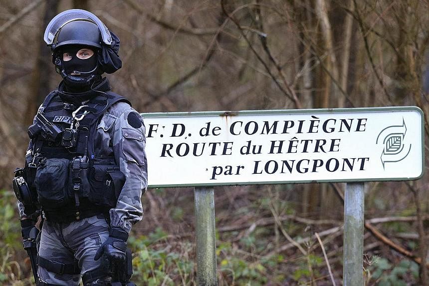 A member of GIPN, (French National Police Intervention Groups) is pictured in Corcy, near Villers-Cotterets, north-east of Paris, on Jan 8, 2015, where the two armed suspects from the attack on French satirical weekly newspaper Charlie Hebdo were spo