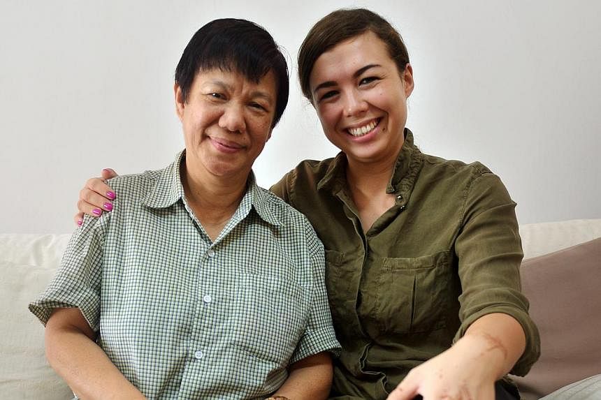 Ms Colleen Turzynski with Madam Chan Yoke Mei, her late mum's best friend. Madam Chan showed her sepia-toned photos of her mother with friends. "She knows more about my mum than I do," said Ms Turzynski.