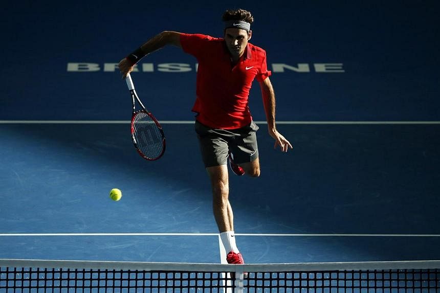 Roger Federer of Switzerland plays a shot at the net during his men's singles semi final win over Grigor Dimitrov of Bulgaria at the Brisbane International tennis tournament in Brisbane, on Jan 10, 2015. -- PHOTO: REUTERS