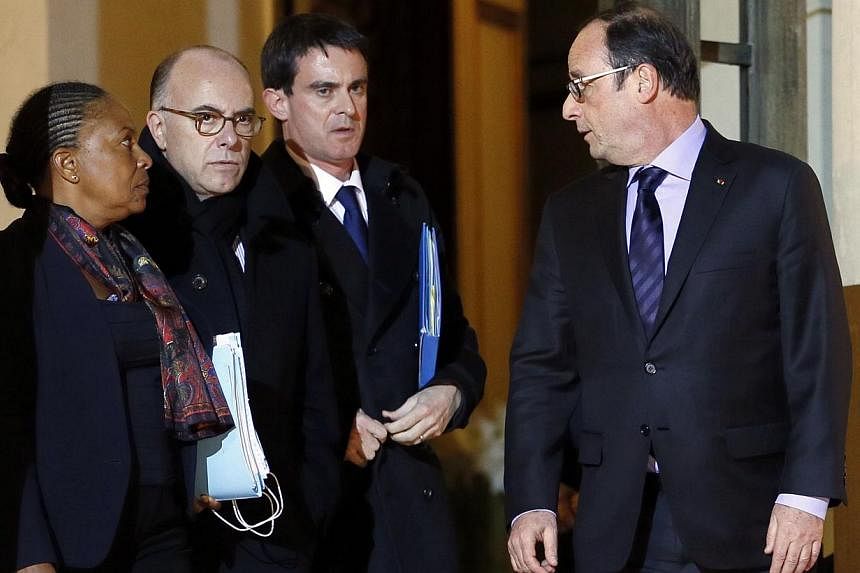 French President Francois Hollande (right) bids farewell to (from left) Justice Minister Christiane Taubira, Interior Minister Bernard Cazeneuve and French Prime Minister Manuel Valls after holding a crisis meeting, on Jan 9, 2015 at the Elysee Palac