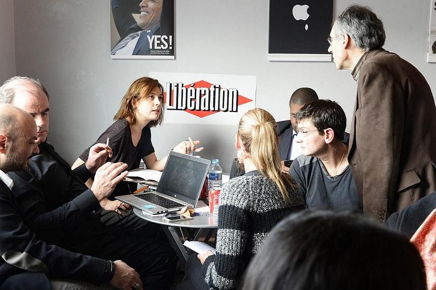 The office at the headquarters of Liberation on Jan 9, 2015 in Paris, as editorial staff of French satirical newspaper Charlie Hebdo and Liberation gather. -- PHOTO: AFP