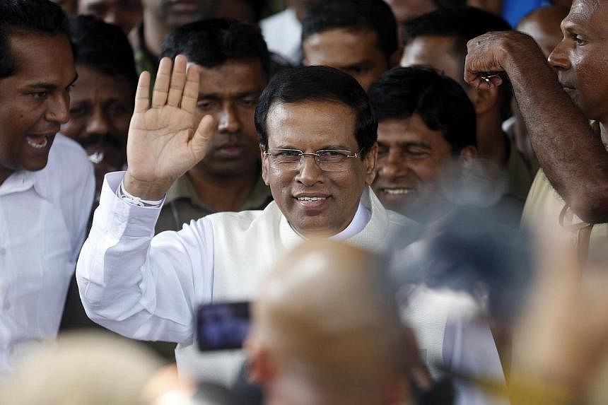 Sri Lanka's newly elected President, Mr Mithripala Sirisena, waving at the media as he leaves election commission in Colombo on Jan 9, 2015. -- PHOTO: REUTERS