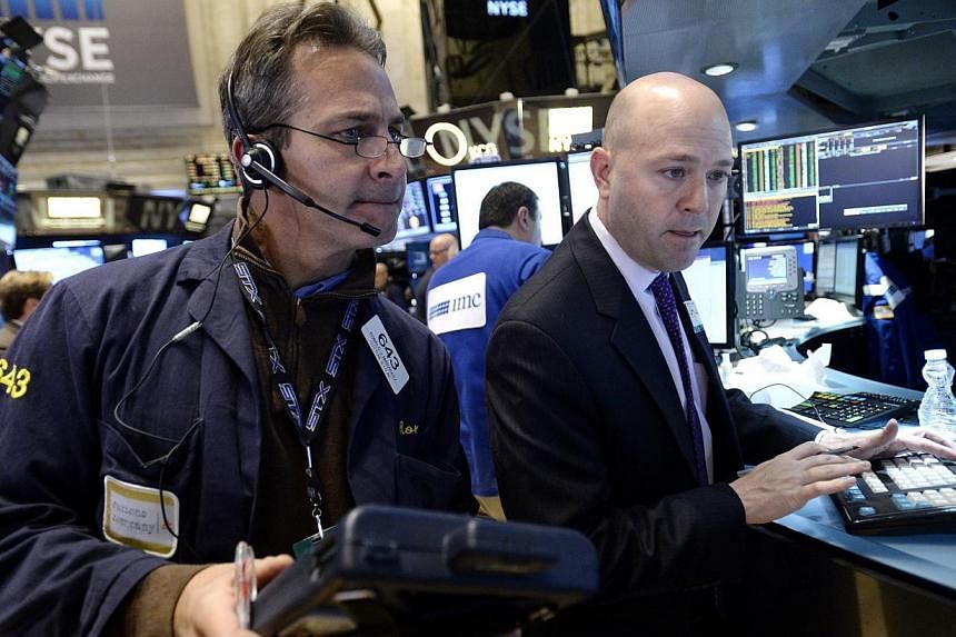 Traders working on the floor of the New York Stock Exchange on Jan 8, 2015. The Dow swung more than 100 points all five days this week in a volatile week that ended modestly lower. -- PHOTO: EPA