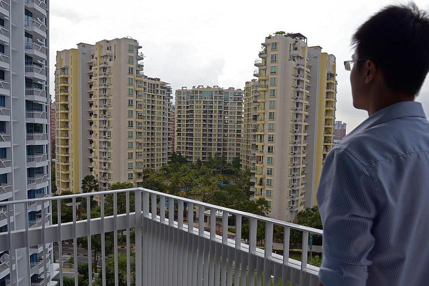 A man looking at a condominium at Paisir Ris Drive 1. A spate of data on the Singapore economy's performance in December, from SRX Property's flash figures for condominium resale prices to private housing rentals, is set to be released this week. -- 
