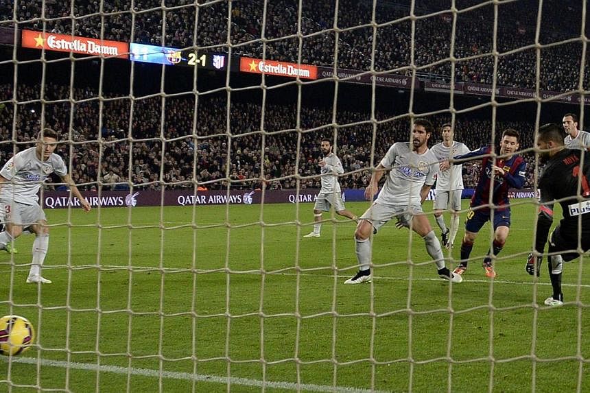 Barcelona's Argentinian forward Lionel Messi scores his side's third and final goal.&nbsp;-- PHOTO: AFP