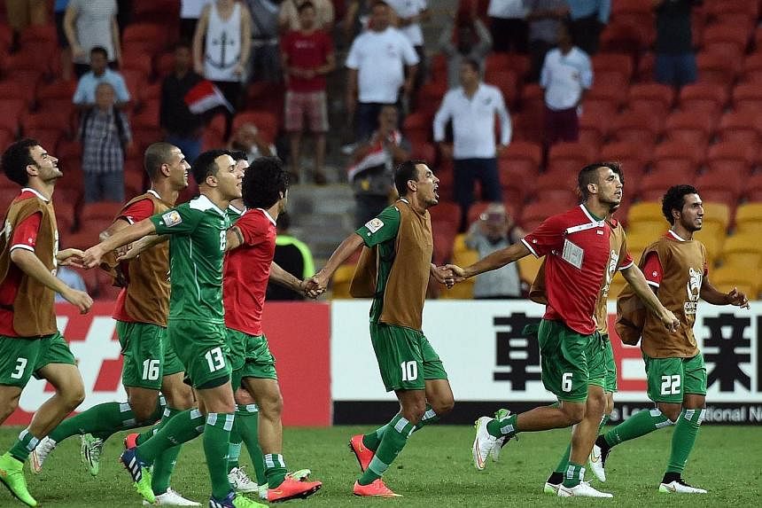Iraqi players celebrate their victory over Jordan in the first round Asian Cup football match between Jordan and Iraq at the Suncorp Stadium in Brisbane on Jan 12, 2015.&nbsp;A magical goal from midfielder Yaser Kasim gave Iraq a crucial 1-0 win over