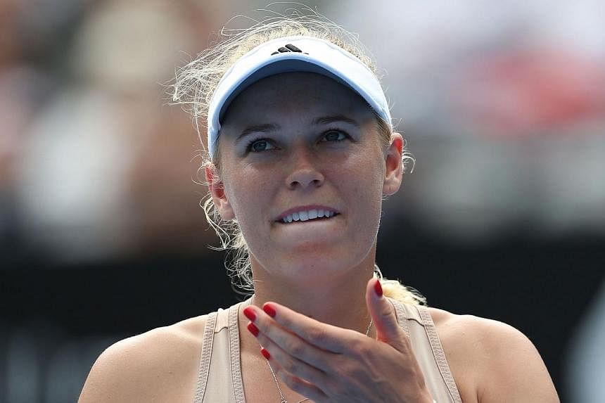 Caroline Wozniacki of Denmark retires hurt after injuring her wrist in her match with Barbora Zahlavova Strycova of Czech Republic during their women's singles match on day two of the Sydney International tennis tournament in Sydney on Jan 12, 2015. 