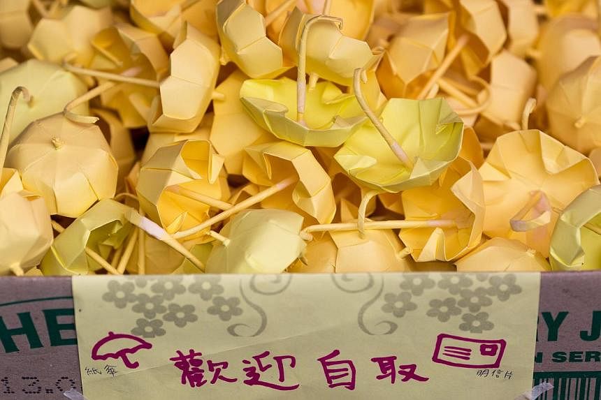 Paper yellow mini umbrellas sit in a box as they are given away by protesters outside the Legislative Council building in Hong Kong, China, on Jan 7, 2014.&nbsp;-- PHOTO: EPA