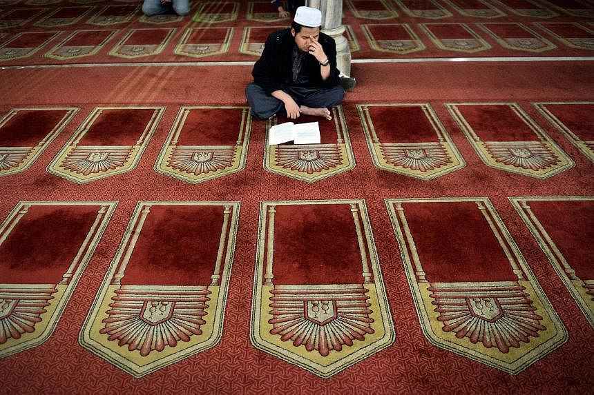 An Egyptian reading from the Quran in a Cairo mosque. "In Islam," says scholar Maulana Wahiduddin Khan, "blasphemy is a subject of intellectual discussion rather than a subject of physical punishment."