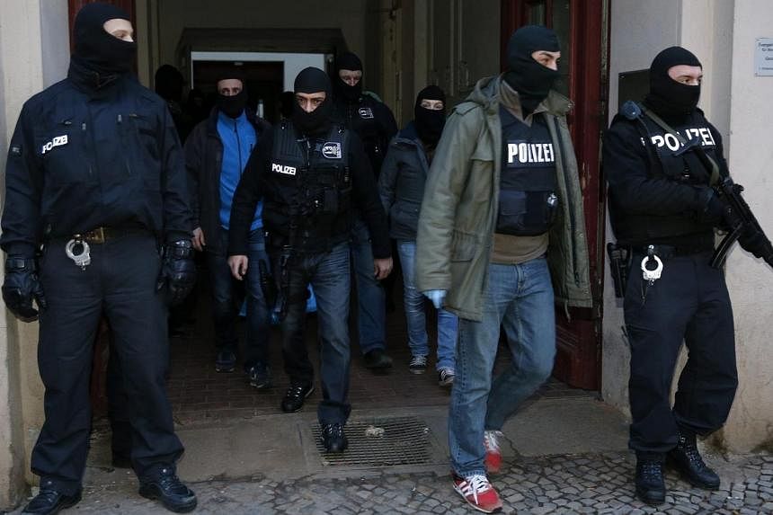 German special police units leave an apartment building in the Wedding district in Berlin on Jan 16, 2015.&nbsp;More than 200 German police officers raided suspected Islamist cells in and around Berlin early on Friday, arresting an alleged leader of 