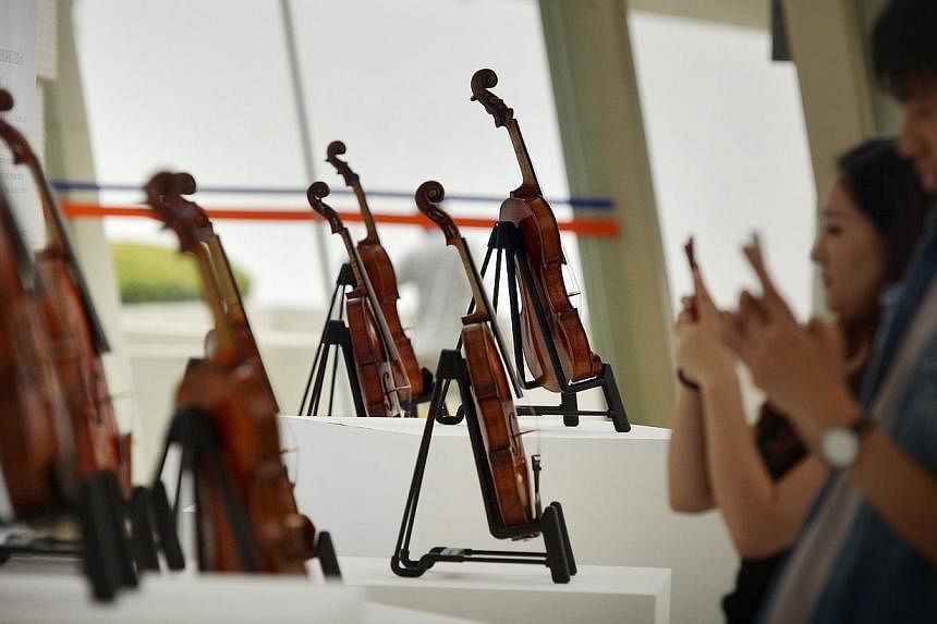Rare violins such as Stradivari and Amati from the Rin Collection go on display as part of the Singapore International Violin Competition at the Yong Siew Toh Conservatory of Music, National University of Singapore. -- ST PHOTO: ALPHONSUS CHERN