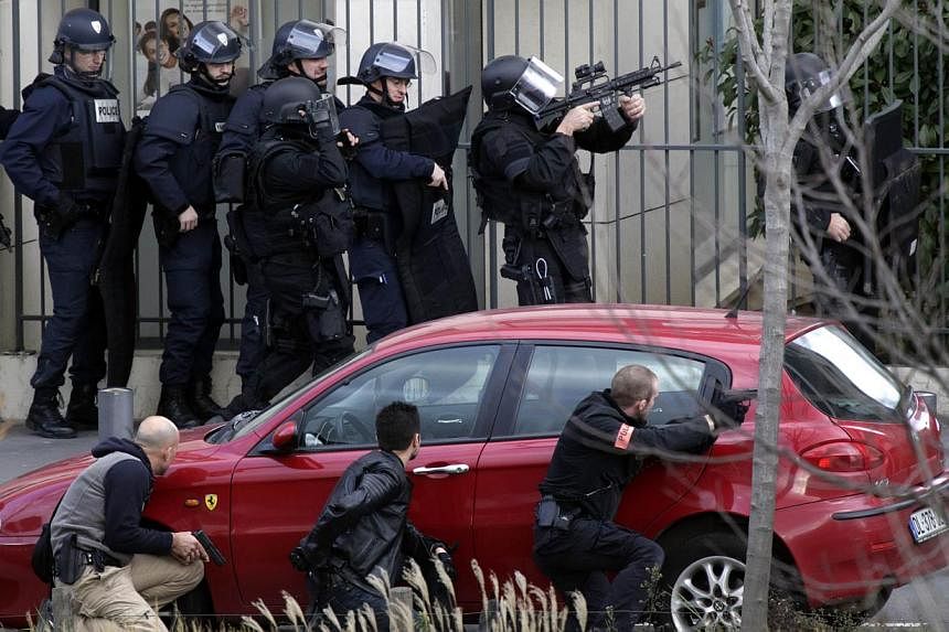 French Research and Intervention Brigades (BRI) policemen officers prepare near the post office where an armed man is holed up with two hostages on Jan 16, 2015, in Colombes, outside Paris, though there is no known link with last week's jihadist atta