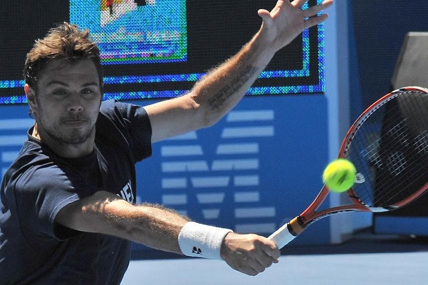 Stan Wawrinka of Switzerland hits a return during a training session ahead of the Australian Open tennis tournament in Melbourne on Jan 16, 2015. The defending champion was on Friday pitted in the top half of the draw at the Australian Open with Nova