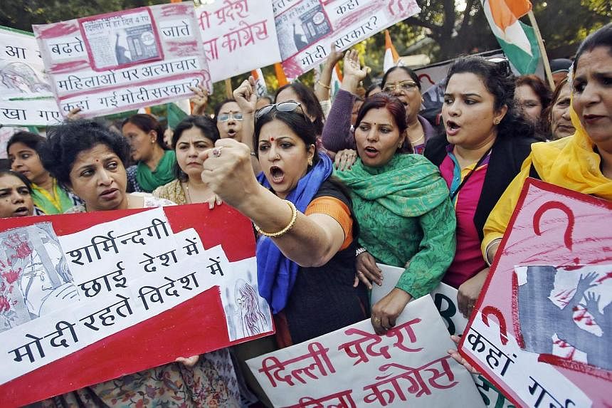 Members of All India Mahila Congress, women's wing of Congress party, shout slogans and carry placards during a protest against the rape of a female passenger, in New Delhi on Dec 8, 2014. The passenger has &nbsp;hired a prominent lawyer to sue the o