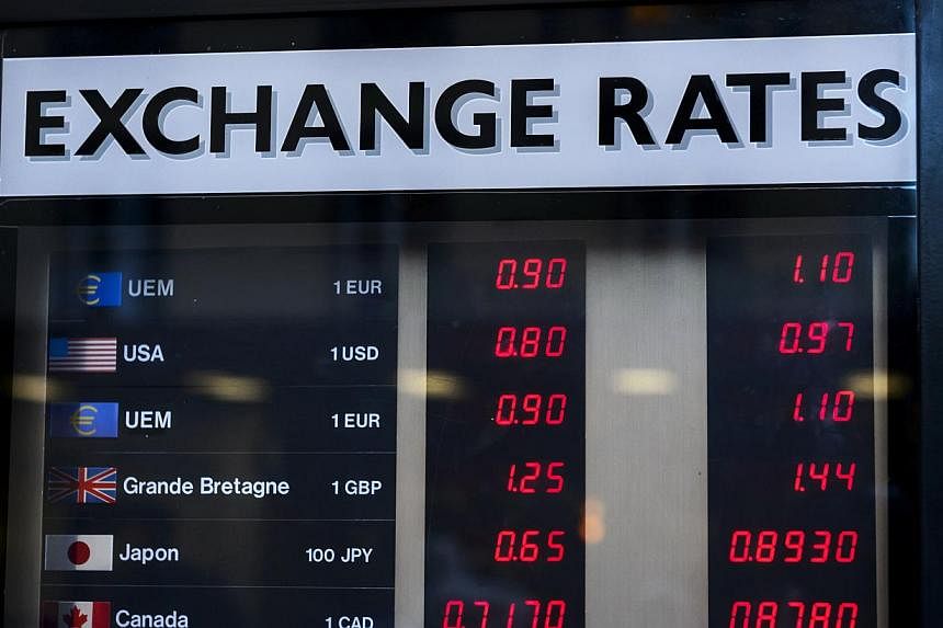 Currency rates displayed at an exchange office in Geneva on Jan 15, 2015. -- PHOTO: AFP