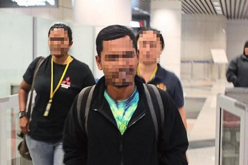 Counter Terrorism Division officers detained the suspect (centre) at KL airport on his arrival in Malaysia. -- PHOTO: THE STAR/ASIA NEWS NETWORK&nbsp;