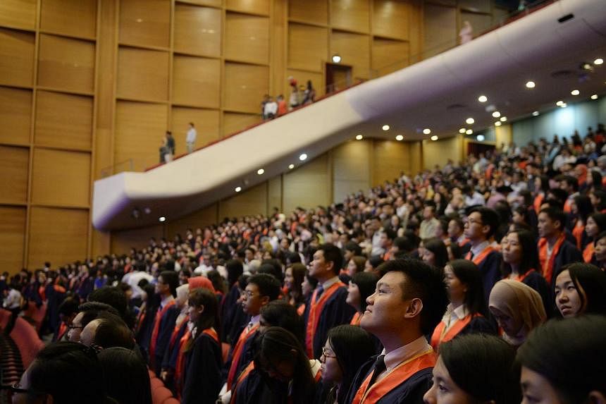 Graduants at the National Institute of Education (NIE) Teachers' Investiture Ceremony pictured after singing the national anthem on Jan 16, 2015. -- ST PHOTO: MARK CHEONG
