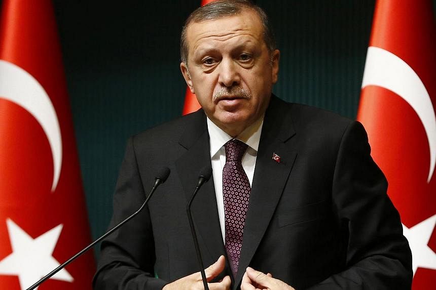 Turkish President Recep Tayyip Erdogan (above) on Friday lashed out at Charlie Hebdo for its "provocative" publications about Islam, saying the French satirical weekly incited hatred and racism. -- PHOTO: REUTERS