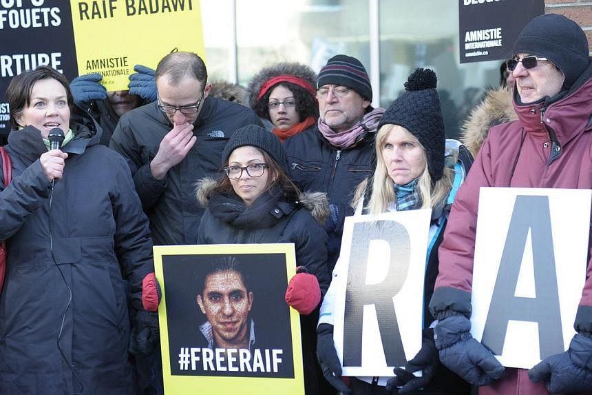 Ensaf Haidar (centre), the wife of Saudi blogger Raef Badawi, holds a vigil in Montreal, Quebec on Jan 13, 2015 urging Saudi Arabia to free her husband who was flogged in public Jan 9, 2015 near a mosque in the Red Sea city of Jeddah, receiving 50 la