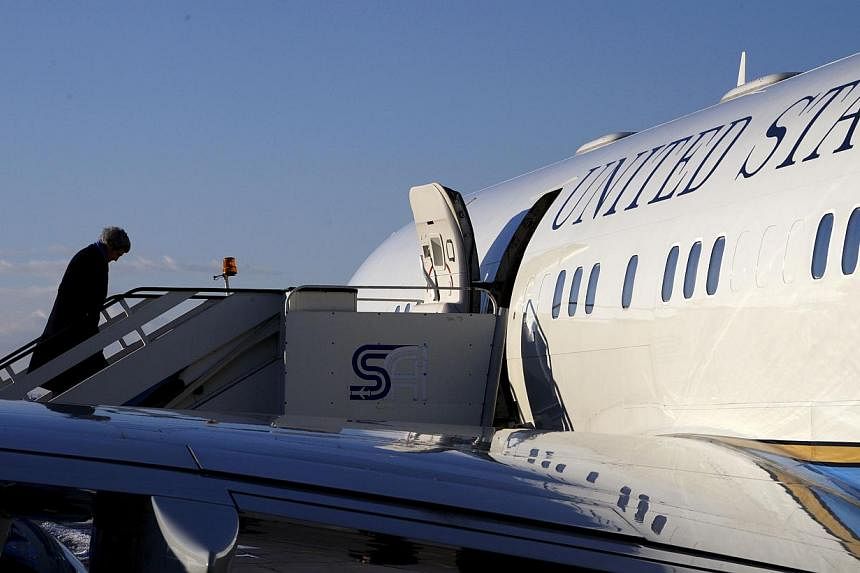 US Secretary of State John Kerry boards his plane in Sofia for a flight to Paris on Jan 15, 2015. -- PHOTO: REUTERS
