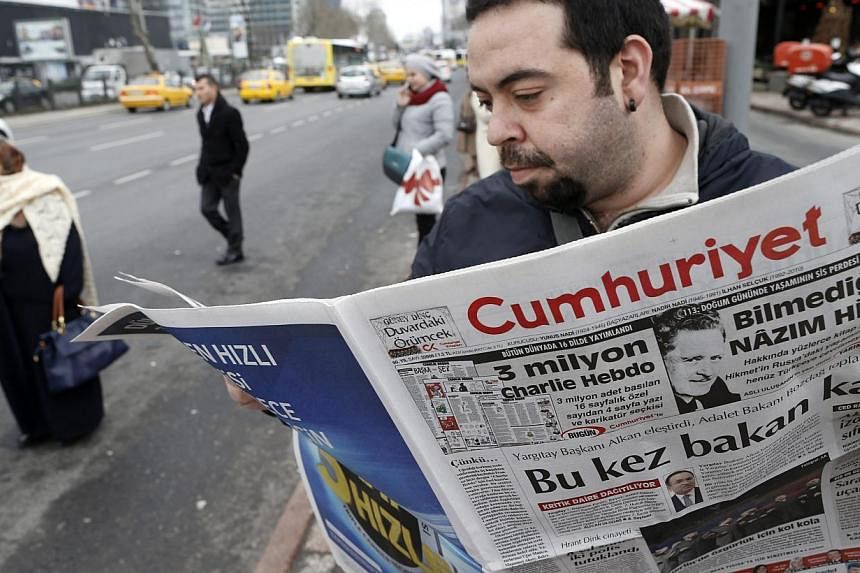A Turkish man reads an edition of the Cumhuriyet daily newspaper featuring&nbsp;a four-page Charlie Hebdo pull-out translated into Turkish including cartoons satirising Nigerian Islamist group Boko Haram and Islamic State in Iraq and Syria&nbsp;in Is