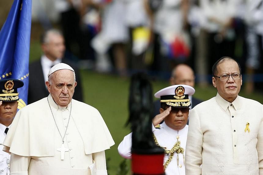 Pope Francis being escorted by Philippine President Benigno Aquino III during the arrival ceremony at Malacanang presidential palace in Manila, Philippines, on Jan 16 2015. -- PHOTO: EPA
