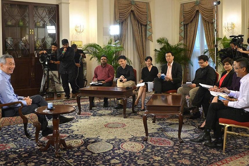 Prime Minister Lee Hsien Loong (left) during an interview with Singapore media at the Istana on Jan 14, 2015. -- ST PHOTO: ALPHONSUS CHERN