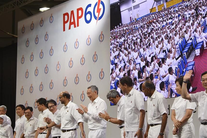Prime Minister Lee Hsien Loong, who is also the People's Action Party’s secretary-general, with other members of the PAP’s new central executive committee at the PAP60 Rally on Dec 7, 2014. -- ST PHOTO: MARK CHEONG