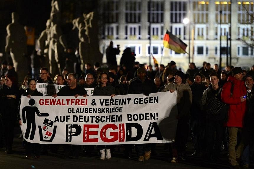 A picture taken on Jan 12, 2015 shows sympathizers of German right-wing populist movement Pegida (Patriotic Europeans Against the Islamisation of the Occident) attending their twelfth march in Dresden, eastern Germany.&nbsp;Germany's anti-Islamic Peg