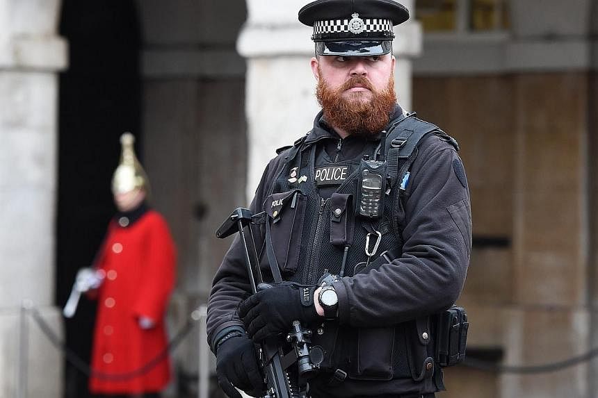 An armed policeman standing guard at Downing Street in London, Britain, on Jan 12, 2015.&nbsp;Britain's ability to prevent terrorist attacks is hampered by outdated laws that are "no longer fit for purpose", a former MI5 chief said in an interview pu