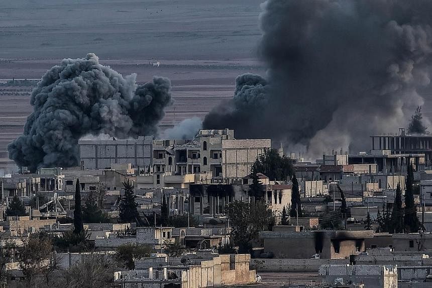 Smoke rising from the city of Kobane after an airstrike from US-led coalition planes on Nov 9, 2014.&nbsp;Once poised to overrun the Syrian town of Kobane, the Islamic State in Iraq and Syria (ISIS) group has suffered a damaging blow to its ambitions