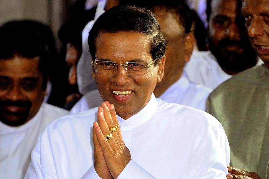 Sri Lanka's newly-elected president Maithripala Sirisena gestures after being sworn in at Independence Square in Colombo on Jan 9, 2015.&nbsp;Sri Lanka's new government will review Chinese infrastructure projects awarded under the previous administra