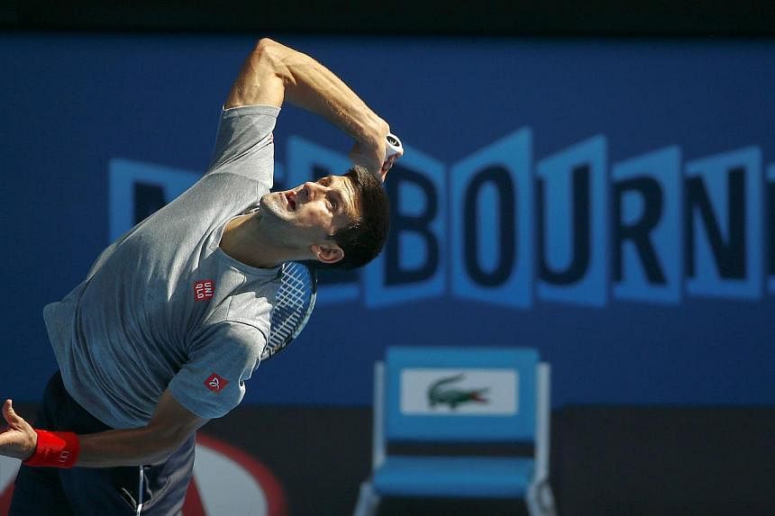 Serbia's Novak Djokovic serves during a practice session on Rod Laver Arena at Melbourne Park on Jan 18, 2015.&nbsp;The world No. 1 seed said on Sunday he has shrugged off a stomach bug and has a good chance to win the Australian Open on the 10th ann