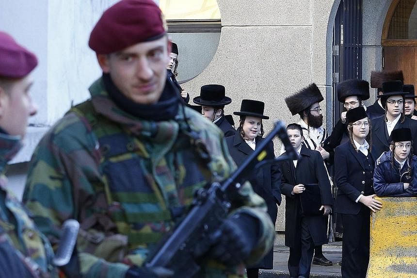 Belgian paratroopers keep guard outside a Jewish school in central city of Antwerp on Jan 17, 2015.&nbsp;The arrests of at least four people by Greek anti-terrorism police are not linked to a probe into a militant cell broken up this week in Belgium,