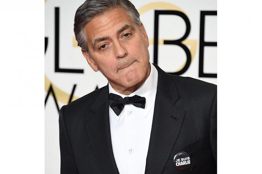 Actor George Clooney wears a "Je suis Charlie" button as he arrives on the red carpet for the 72nd annual Golden Globe Awards, on Jan 11, 2015.&nbsp;Iran has banned a reformist newspaper for publishing on its front page the headline “I am Charlie",