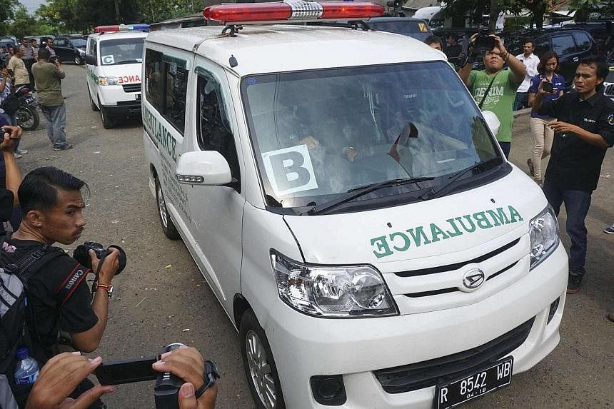 A convoy of ambulances carrying coffins make their way to Nusa Kambangan prison at Wijayapura quay, Cilacap, Central Java, on Jan 17, 2015. Indonesia on Sunday put to death six people convicted of drugs offences, including five foreigners, in the fir