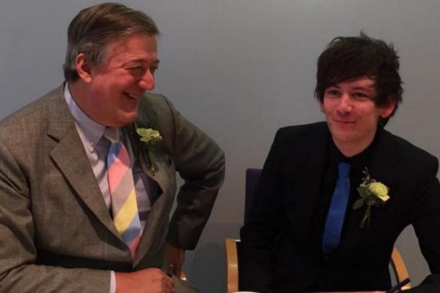 British actor Stephen Fry (left) and boyfriend&nbsp;Elliot Spencer were wed at a register office in Britain. -- PHOTO: TWITTER