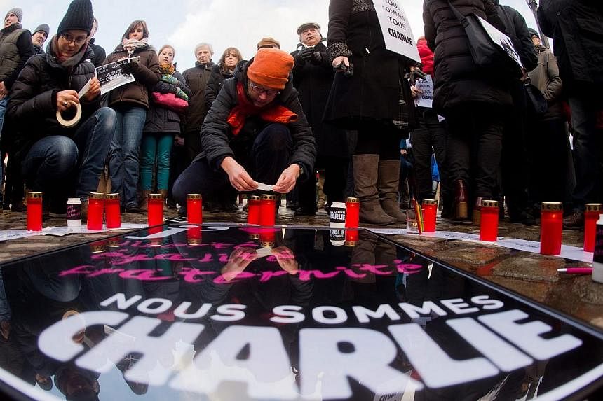 People gather to express solidarity for the victims of the attack on the French satirical magazine 'Charlie Hebdo' on the Opernplace in Hanover, Germany on Jan 11, 2015.&nbsp;The attacks in Paris and the radical Islamist cell dismantled in Brussels h